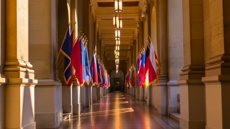 grand hallway lined with flags and architectural columns