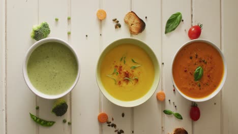 video of diverse vegetable soups and ingredients lying on white surface