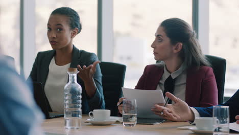 corporate business women brainstorming in boardroom meeting discussing strategy colleagues sharing ideas working on deadline collaborating in office 4k