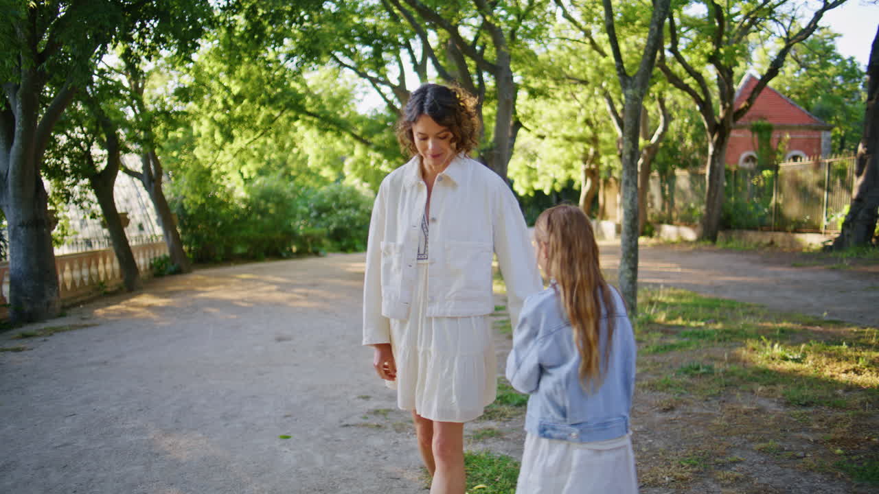 Mom child walking park at sunny day closeup. Carefree mother daughter together