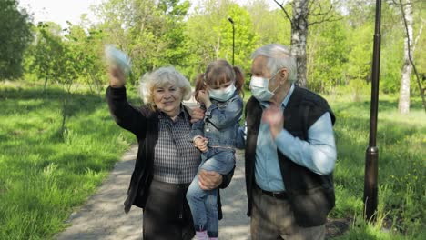 grandparents with granddaughter takes off masks after coronavirus quarantine end