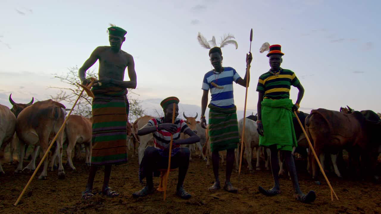 Karamojong Cattle Farmers Standing Amidst Their Cows in Uganda, Africa - Close Up