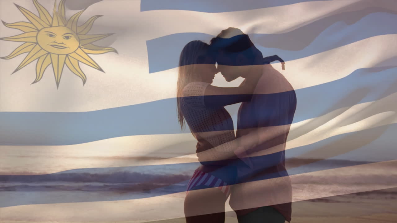 Embracing couple on beach with Uruguay flag animation in background