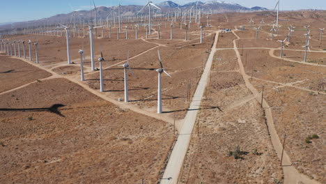 Camera-moves-forward-and-tilts-up-revealing-a-solar-farm-with-a-mountain-range-in-the-background