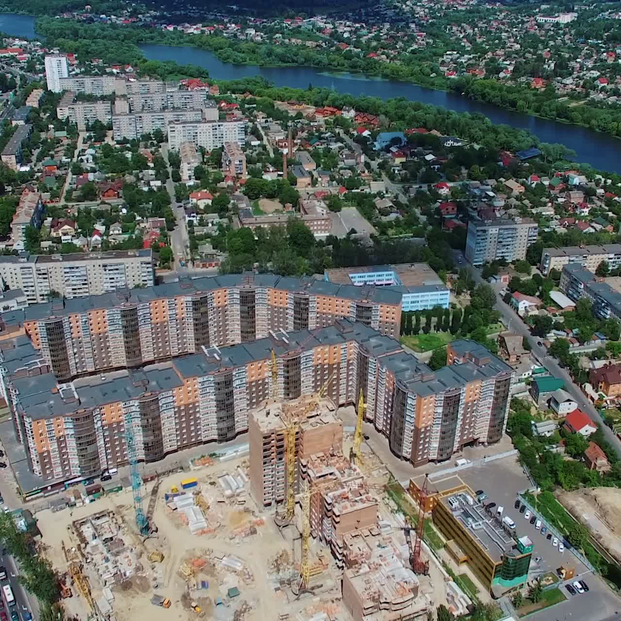 New architectural buildings in the downtown. Panoramic view of a city with a construction site of a modern district. Aerial view.