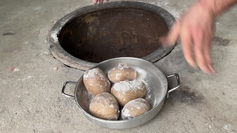 remove potato cooked naturally old traditional ground clay oven that burnt coal charcoal firewood bone fire camp fire slowly baked healthy food concept fried crunchy potato with crispy skin in pan