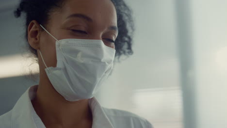 portrait african nurse talking to interlocutor in clinic. doctor making checkup.