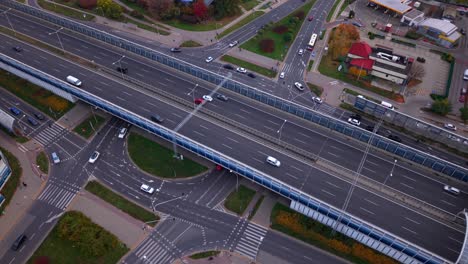 drone circles over urban city roundabout traffic junction of trasa torunska highway, warsaw