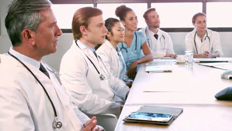 medical team talking together while applauding