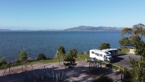 campervan on campground on the edge of a lake