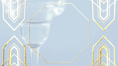 Golden-frame-design-pattern-over-close-up-of-cocktail-glass-against-grey-background