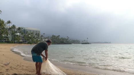 Fisherman-holding-fishing-net-in-the-beach-4k