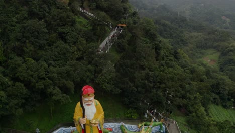 Decorative-elderly-religious-male-statue-on-temple-rooftop