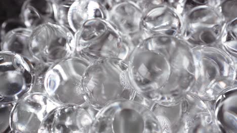 macro view of glass spheres wet abstract light reflections, interesting 4k background footage