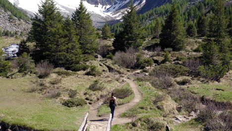 female trekker walking through mountain track