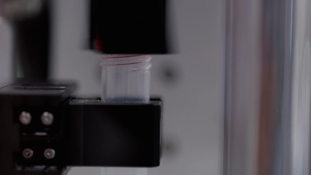 Automated Laboratory Machine Uncapping a Test Tube