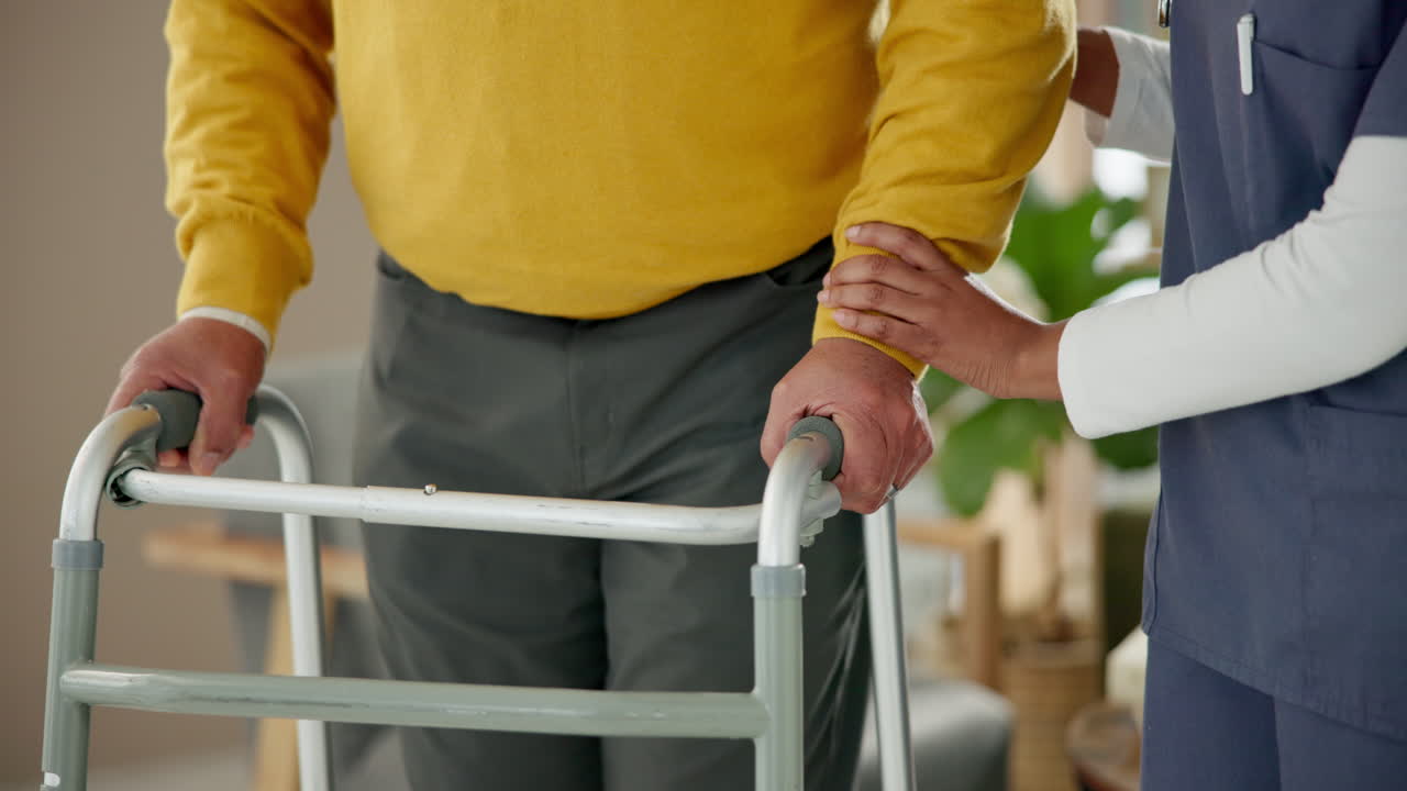 Caregiver assisting elderly man with walker