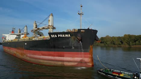 aerial shot of the sea prajna being tugged through the panama canal