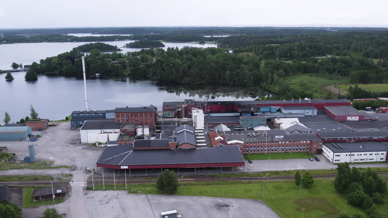 Åsensbruk, sweden showing industrial buildings by a lake , aerial view