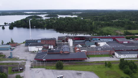 åsensbruk, sweden showing industrial buildings by a lake , aerial view