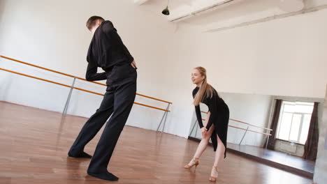 couple practicing dance steps and stretching in a bright studio