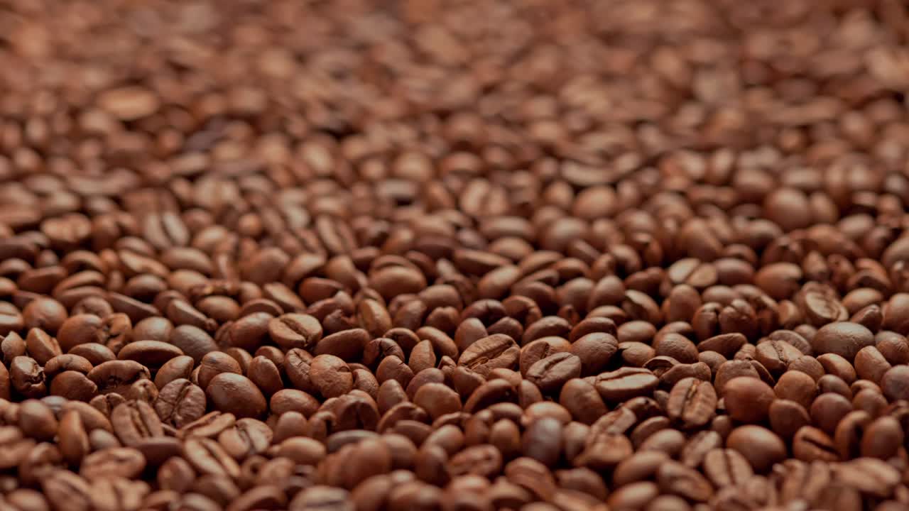 full frame looped spinning background of roasted coffee beans