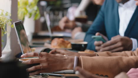 diverse business people hands using laptop computers in busy cafe bustling with activity working online browsing sharing digital email communication