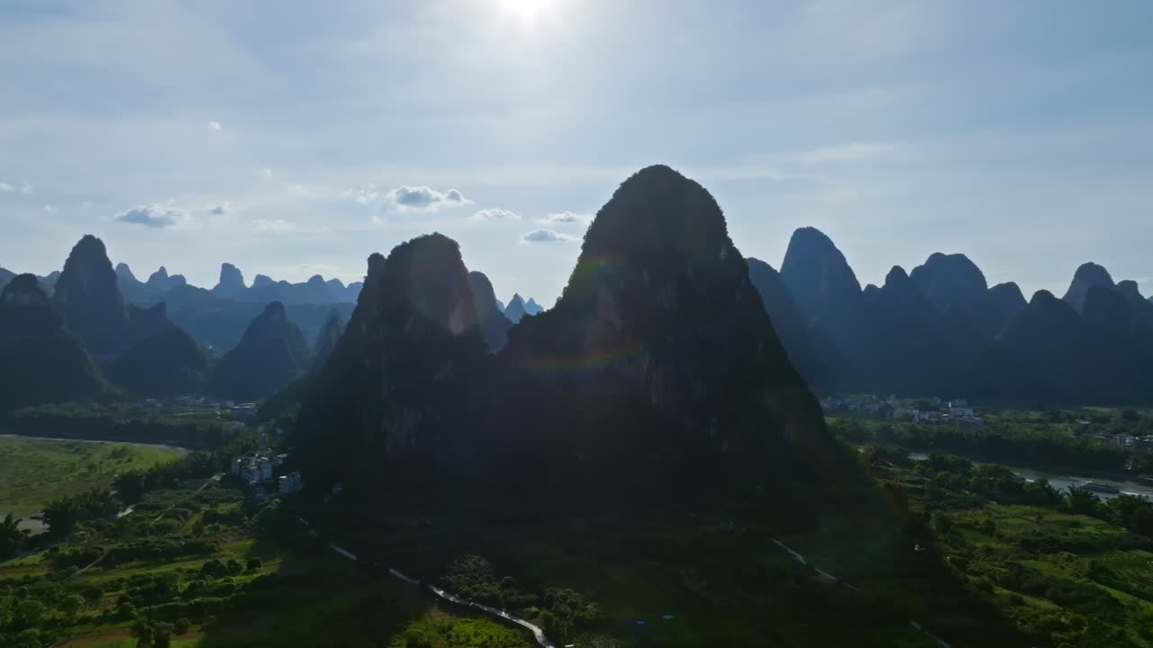 Aerial tracking shot in front of huge karst mountain peaks in Xingping, China