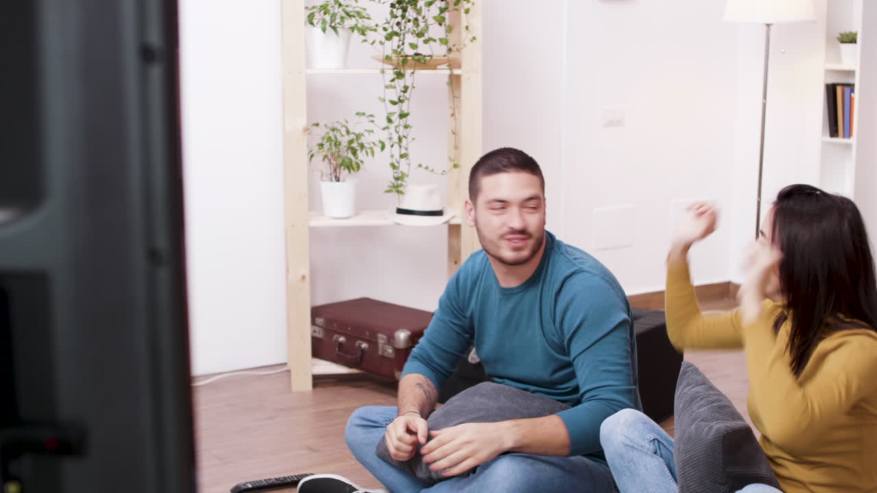 Couple Watching TV and Celebrating
