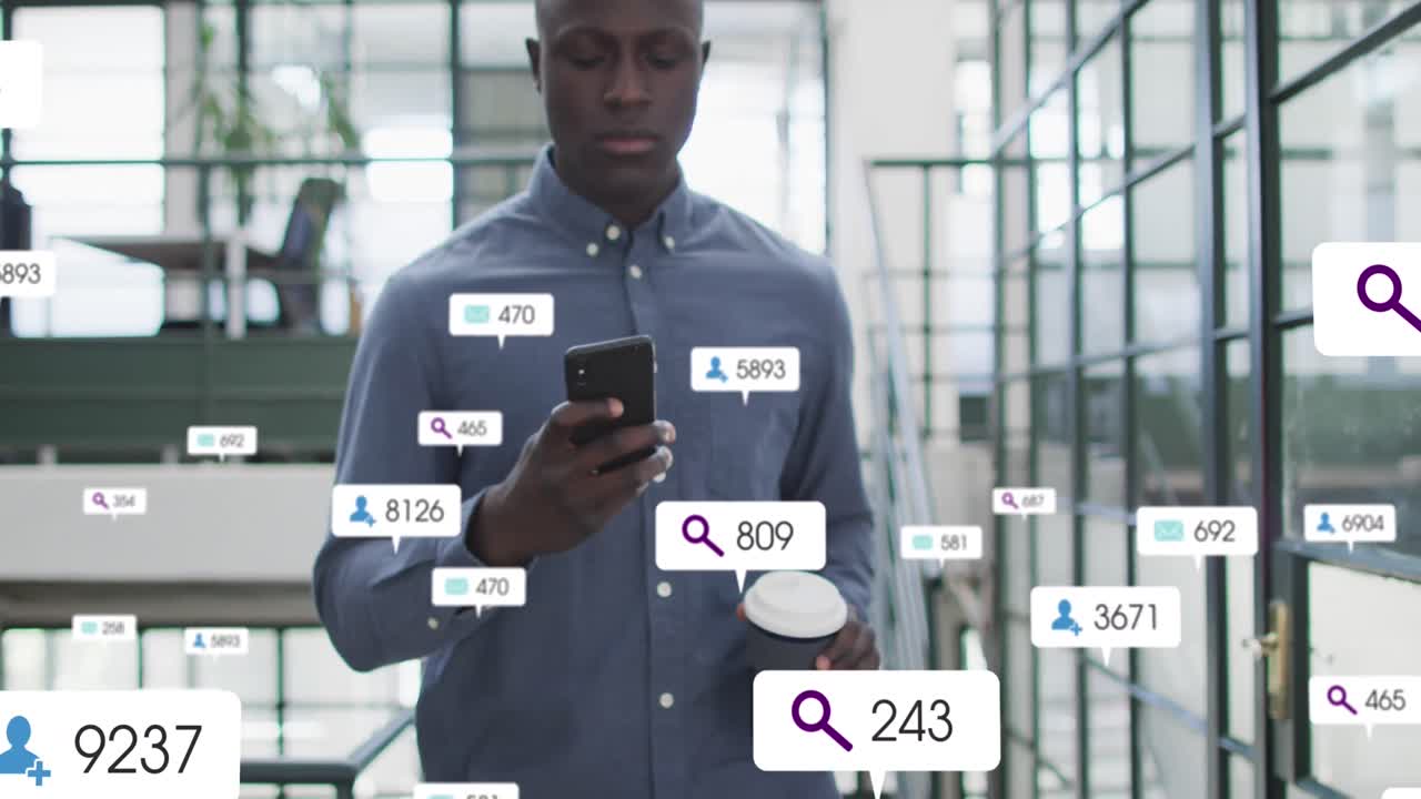 Animation of social media icons and numbers over african american man using smartphone
