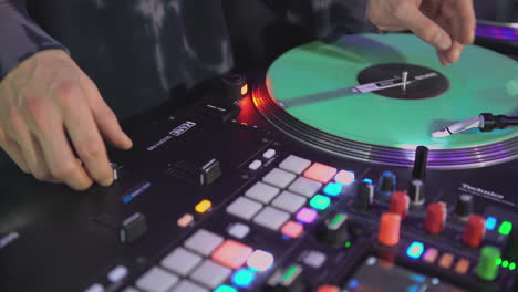 dj mixing on turntable at nightclub