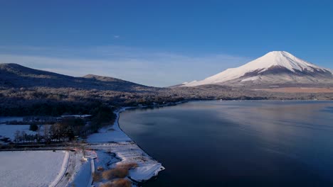 winter time in japan with mt fuji and forest covered in snow next to lake