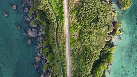 A-drone-shot-of-the-emerald-water-on-the-coast-of-Miyakojima,-Japan-during-Sunrise