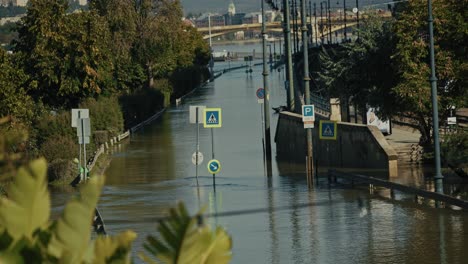 flooded street with submerged road signs and trees in budapest, hungary, during 2024 flood