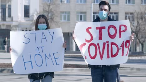 protestors holding signs for covid-19 awareness