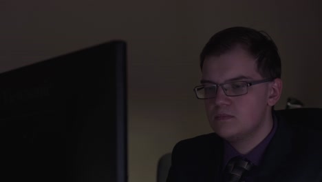 hombre trabajando en la computadora por la noche