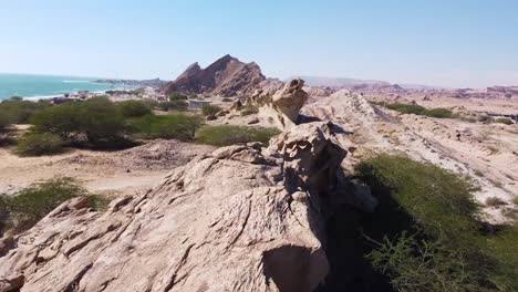 fly over sea landscape rock cliff wind erosion sand formation in coastal rural countryside wide panoramic view of ocean in day time in gulf surfin paddle board diving adventure in qatar uae resort