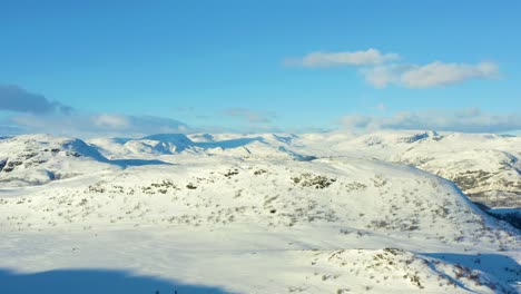 Aerial-over-the-snow-covered-valley-and-mountains-in-Hemsedal,-Norway