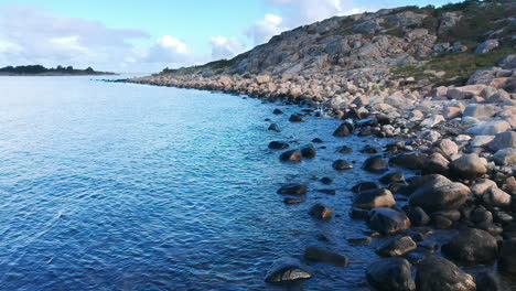 Aerial-drone-shot-of-a-rocky-beach-ocean-coastline-on-the-west-coast-of-Sweden-in-Halland,-outside-of-Gothenburg