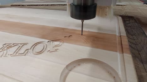 cnc router carving text onto wooden plate