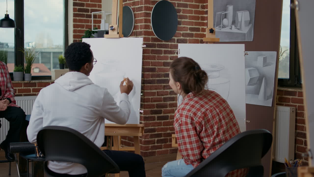 Multi ethnic team of people learning to draw sketch in art class