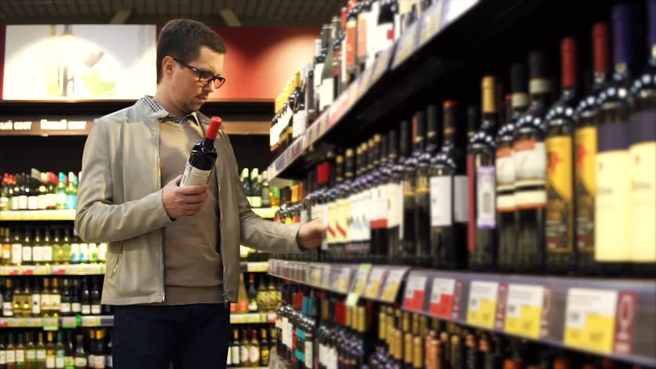 Man Shopping for Wine in a Grocery Store