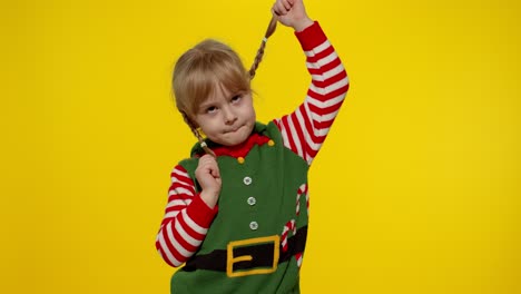 Kid-girl-in-Christmas-elf-Santa-helper-costume-dancing,-fooling-around.-New-Year-holiday-celebration