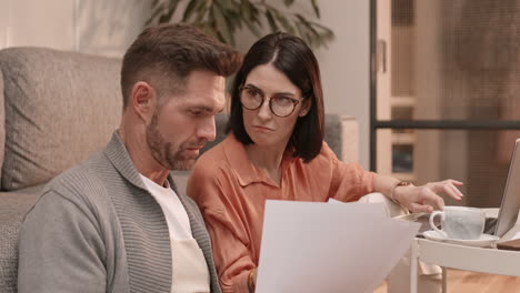 caucasian man and woman reading documents