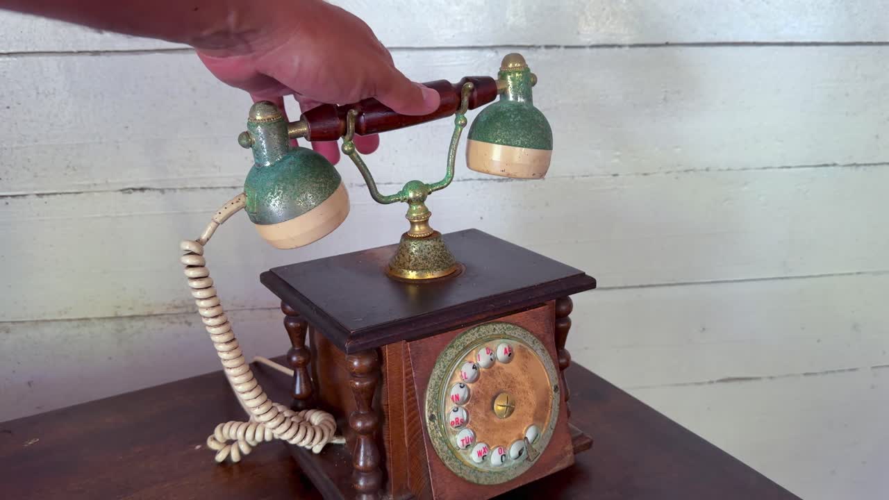 Slow motion of hand answering old vintage phone, Mahe, Seychelles 25fps