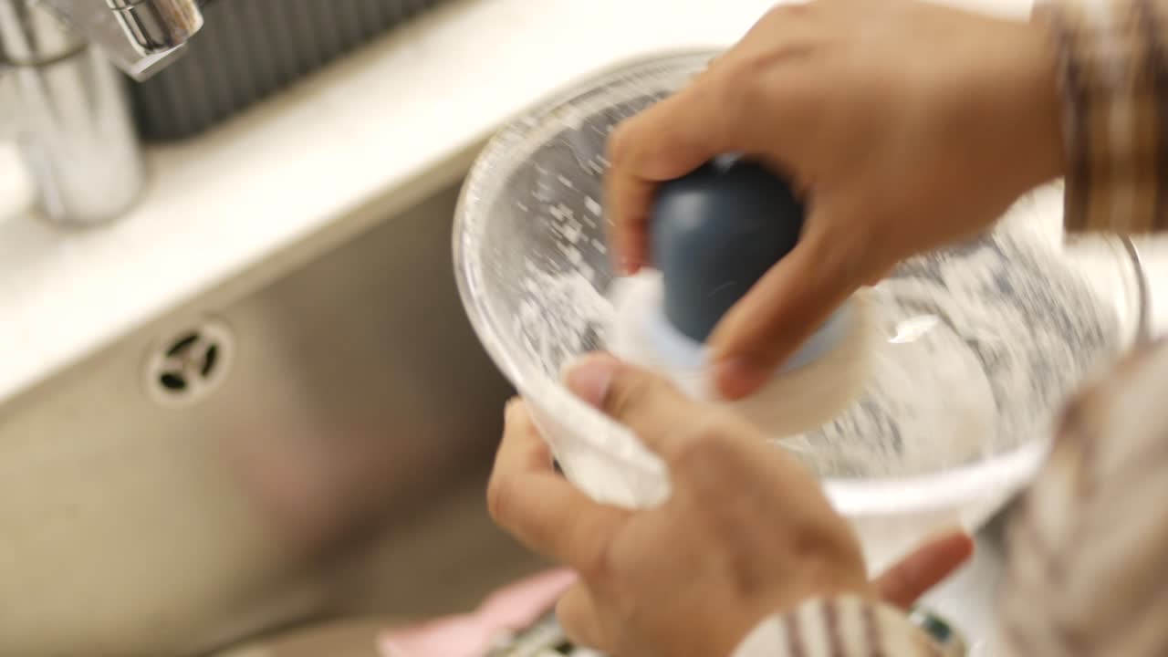 Washing a bowl in the kitchen sink