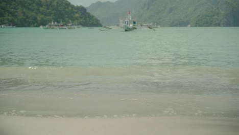 El-Nido-Island-In-The-Philippines---Wonderful-Scenery-Of-Boat-Floating-By-the-Sea-and-Green-Mountain---Beautiful-Tourist-Attraction---Wide-Shot