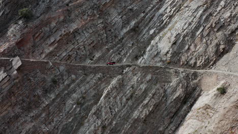 Red-Old-4x4-Jeep-Driving-On-Steep-Cliffside-Towards-Fairy-Meadows-Road-In-Pakistan