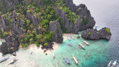 tropical island with steep rock formation and pristine beaches, el nido boat trip, palawan. aerial
