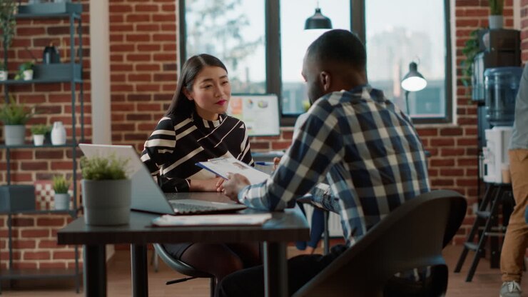 Male recruiter interviewing job seeker about work experience